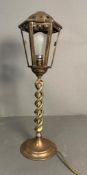 A brass lantern style table lamp on barley twist column base