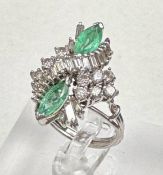 An emerald and diamond ring, designed a s a vertically set elongated cluster with two marquise cut
