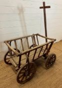 A vintage wooden garden trolley on wooden metal bound wheels (H55cm W80cm D56cm)