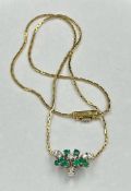 An 18ct diamond and emerald pendant on a 18ct yellow gold necklace, approximate total weight 7.7g