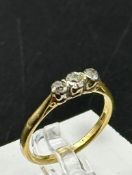 A three stone diamond ring on an 18ct gold setting, size P, approximate weight 3.1g
