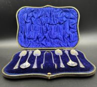 A cased set of six teaspoons with shell bowls and a pair of sugar nips, hallmarked for London 1902