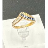 A 9ct gold fashion ring with sapphire and diamond style stones, size K and approximate weight 2.2g