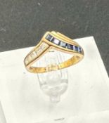 A 9ct gold fashion ring with sapphire and diamond style stones, size K and approximate weight 2.2g