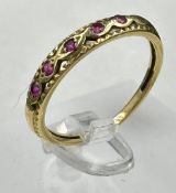 A 9ct gold ring with five garnets , size N, approximate weight 2g