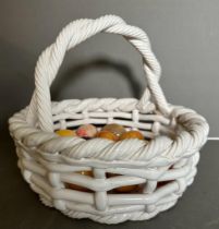A white ceramic basket and a selection of marble eggs