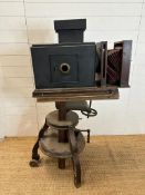 A prop box style camera on a vintage industrial style tripod stand