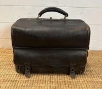 A vintage black leather doctors bag