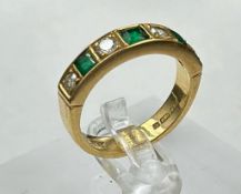 An 18ct gold diamond and emerald ring, approximate total weight 5.7g
