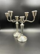 A pair of two arm candlesticks, hallmarked for Birmingham 1971, by A Chick & Sons Ltd
