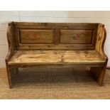 A vintage pine two seater settle with painted floral detail (H90cm W140cm D42cm)