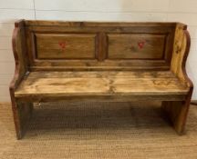 A vintage pine two seater settle with painted floral detail (H90cm W140cm D42cm)