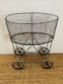 A vintage rolling wire laundry cart (H71cm W63cm D39cm)
