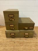 A selection of five green vintage storage boxes