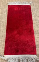 A red ground rug or prayer mat with floral inlay 170x71