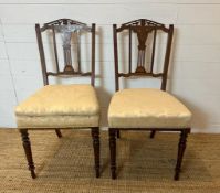 Two Edwardian hall chairs with inlaid backs and turned legs