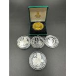 A selection of five silver commemorative coins including a 2008 Britannia.