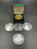 A selection of five silver commemorative coins including a 2008 Britannia.