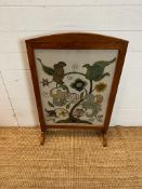 A light oak framed fire screen with glazed front and floral tapestry insert