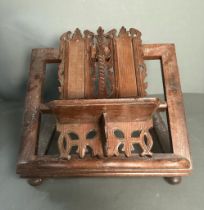 A vintage wooden book or bible stand with carved central plinth