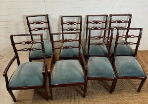 Eight mahogany Regency style dining chairs with carved backs and brass string inlay to include two
