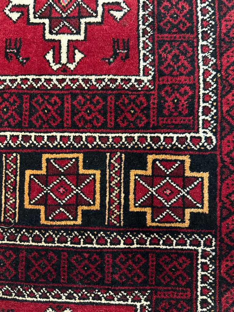 A red ground wool rug with geometric central medallions - Image 3 of 5