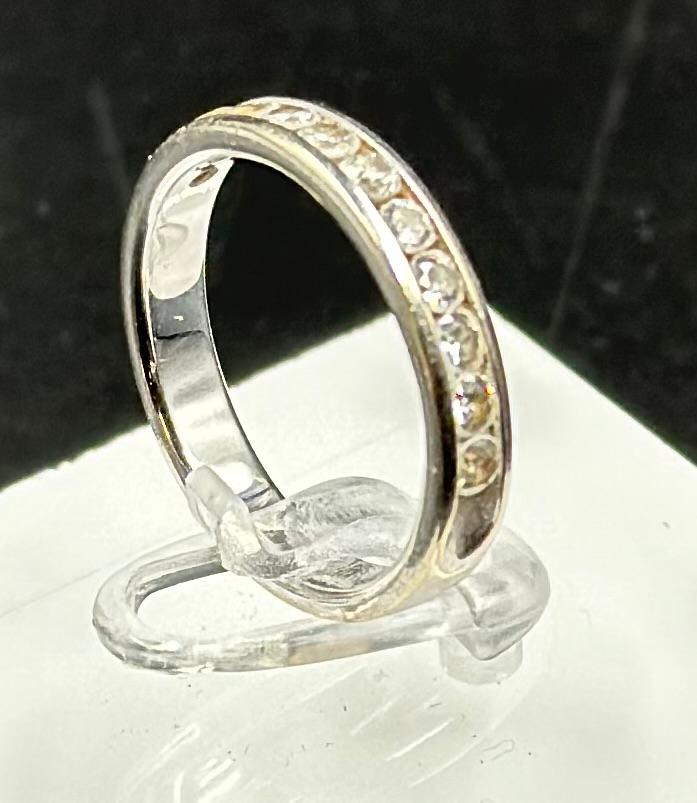 A 14ct white gold half eternity style ring, approximate total weight 3.4g and size N. Being sold