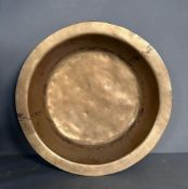 A large brass decorative wall hanging bowl