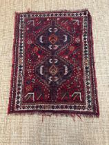 A red ground rug nomadic Shiraz rug in creams, blues and oranges 110cm x 90cm