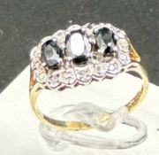 A 9ct gold diamond and sapphire ring, approximate size M1/2
