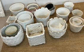A large selection of plant pots, mainly white various sizes and ages