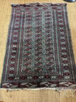 A blue ground wool rug with geometric red and white boarder and geometric central pattern