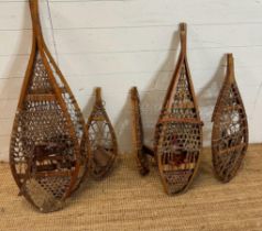 Five pairs of vintage wooden webbed snow shoes