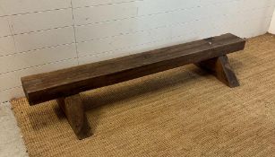 A reclaimed oak bench on triangular feet (H30cm W180cm)
