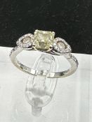 An 18ct white gold decoartive ring set with 1.28ct fancy natural colour radiant cut diamond,