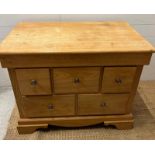 A light oak chest of drawers (H79cm W101cm D63cm)