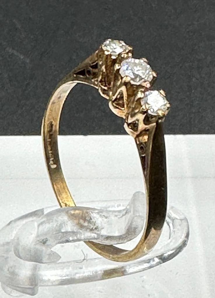 A three stone diamond ring on 9ct gold size L