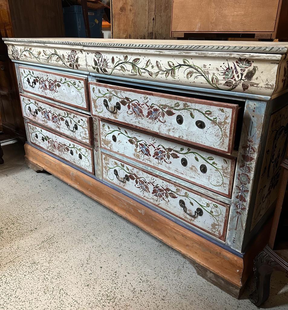 A painted six drawer sideboard with floral motif, two drawers below and two dummy drawers to top (