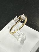A two stone diamond ring on yellow gold setting, approximate size O