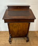 A Victorian inlaid Davenport on castors, flanked by four drawers either side, hinged desk lid and
