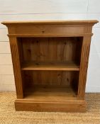 A pine two shelf bookcase with fluted sides (H78cm W66cm D30cm)