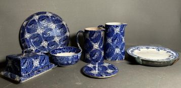 A selection of blue and white ceramics to include a butler dish, Victorian plate warmer and jugs,