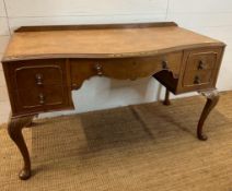 A bow fronted dressing table with galleried top and brass drop handles on cabriole legs (H84cm