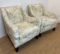 A pair of contemporary arm chairs, upholstered in bamboo leaf pattern fabric