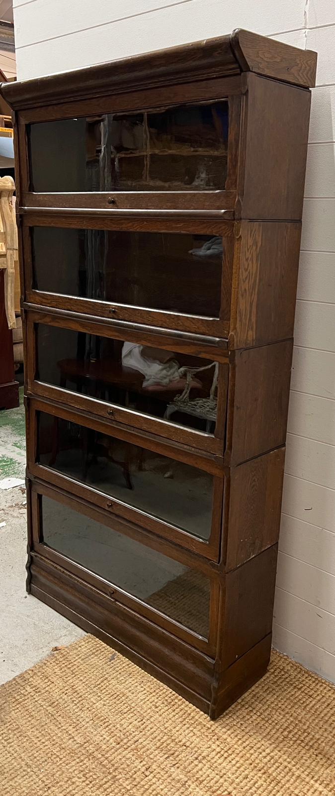 A five tier Casler oak and glazed,barristers bookcase (H166cm W87cm D30cm)