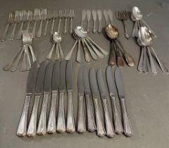 A six place setting cutlery set by Insignia Plate along with some other plated cutlery.