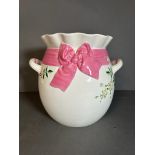 A large glazed two handle vase with pink ribbon and floral relief AF (H28cm)