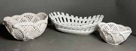 Three white ceramic pierced baskets