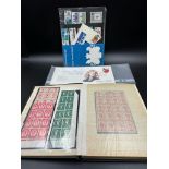 A stamp album containing a small selection of Great British mint stamps along with some from Monaco,