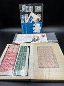 A stamp album containing a small selection of Great British mint stamps along with some from Monaco,